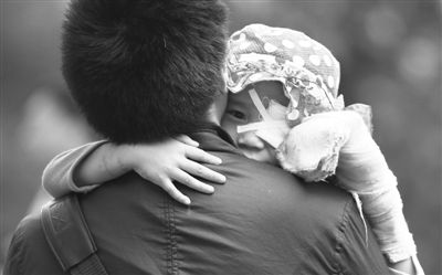 昨日，北京同仁醫(yī)院，被砍傷的彤彤趴在舅舅的肩上。他們剛剛掛完號，正準備回旅館。新京報記者 尹亞飛 攝