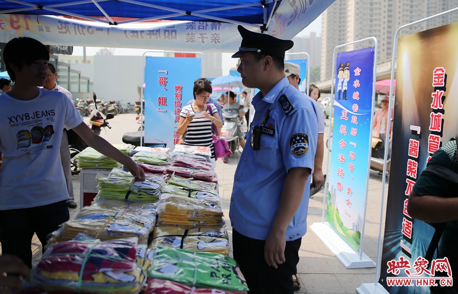 執(zhí)法人員勸導(dǎo)看守?cái)偽坏娜藛T搬離，停止非法占道經(jīng)營(yíng)。